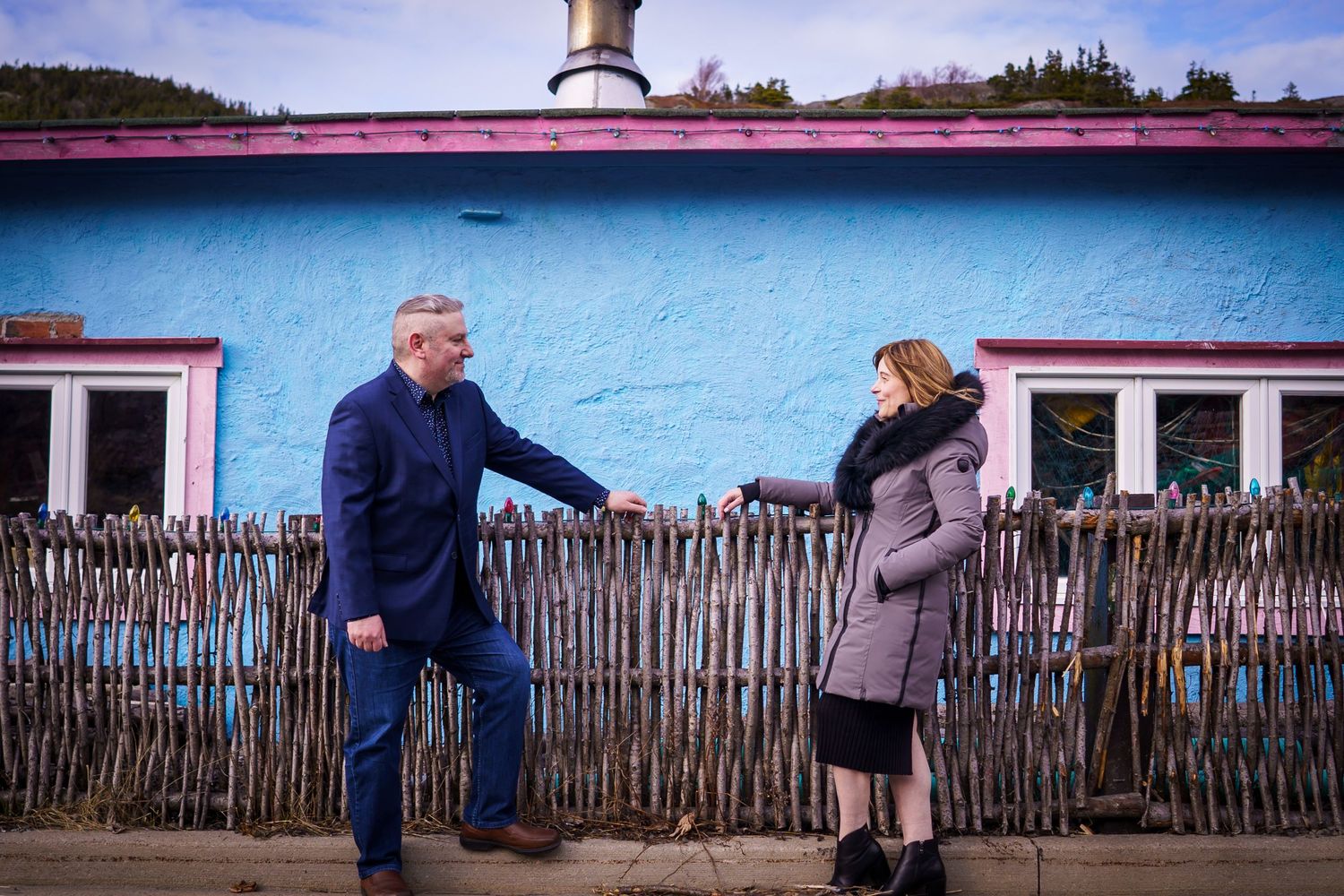 Anniversary photos of a couple at a rustic, rural house in Quidi Vidi Village, St. John's, Newfoundland