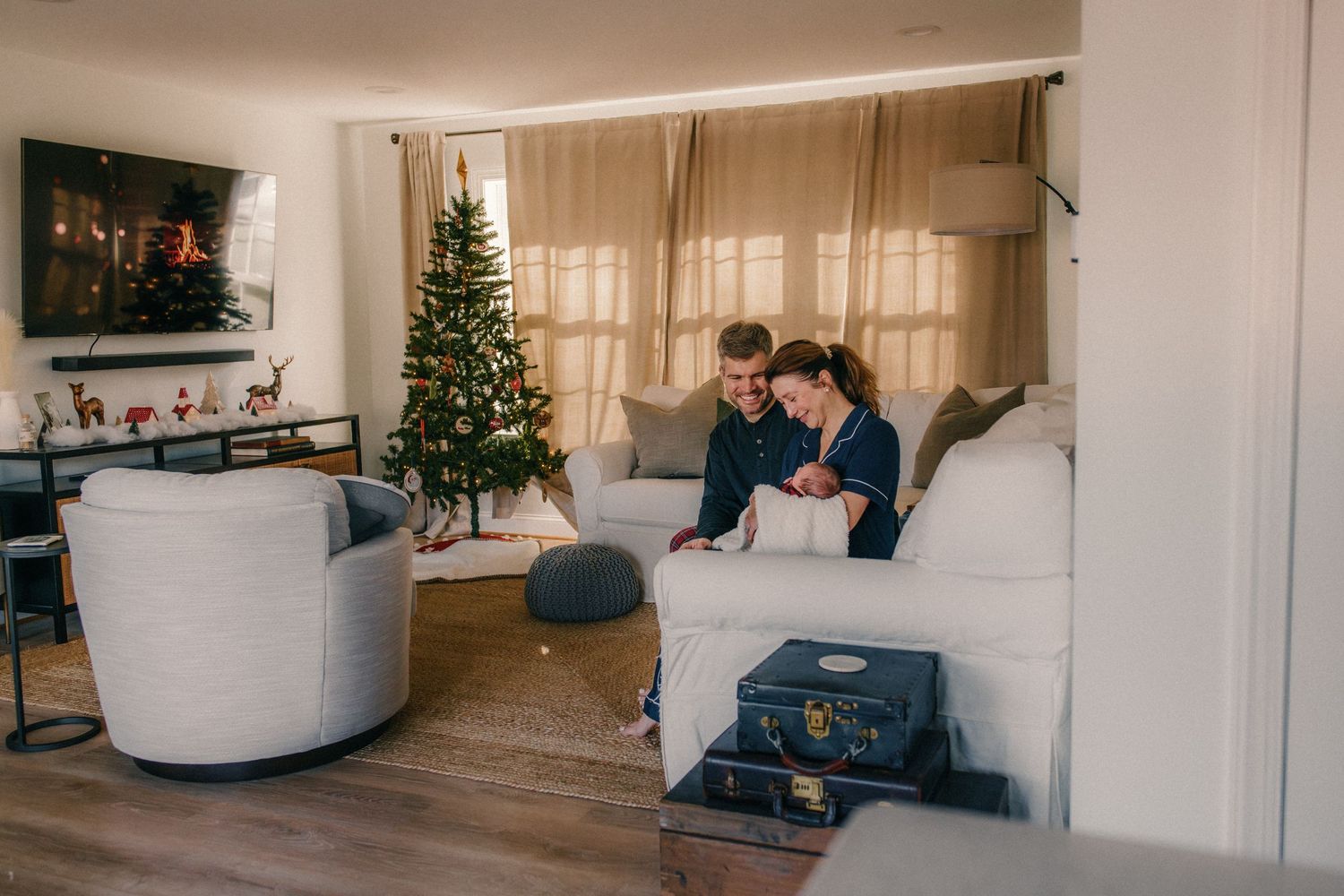 Cozy living room with Christmas tree and sofa during holiday season.