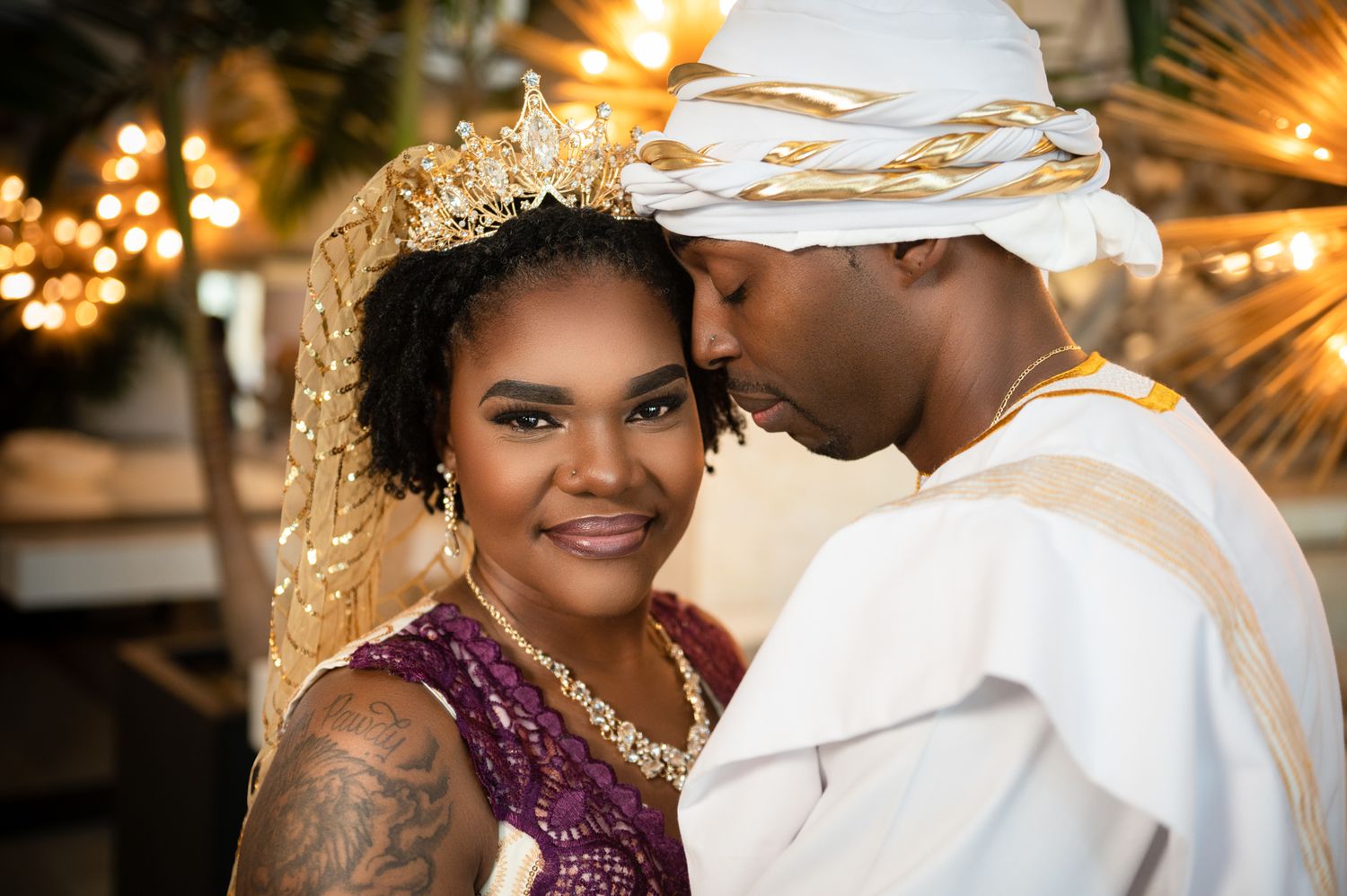 The husband rests his head on his bride as she looks into the camera, captured by Florida destination wedding photographers.