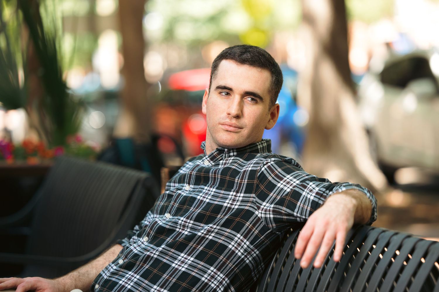 A sequence of photos showing someone in a black sweater turning away from the camera against a blurred outdoor background.