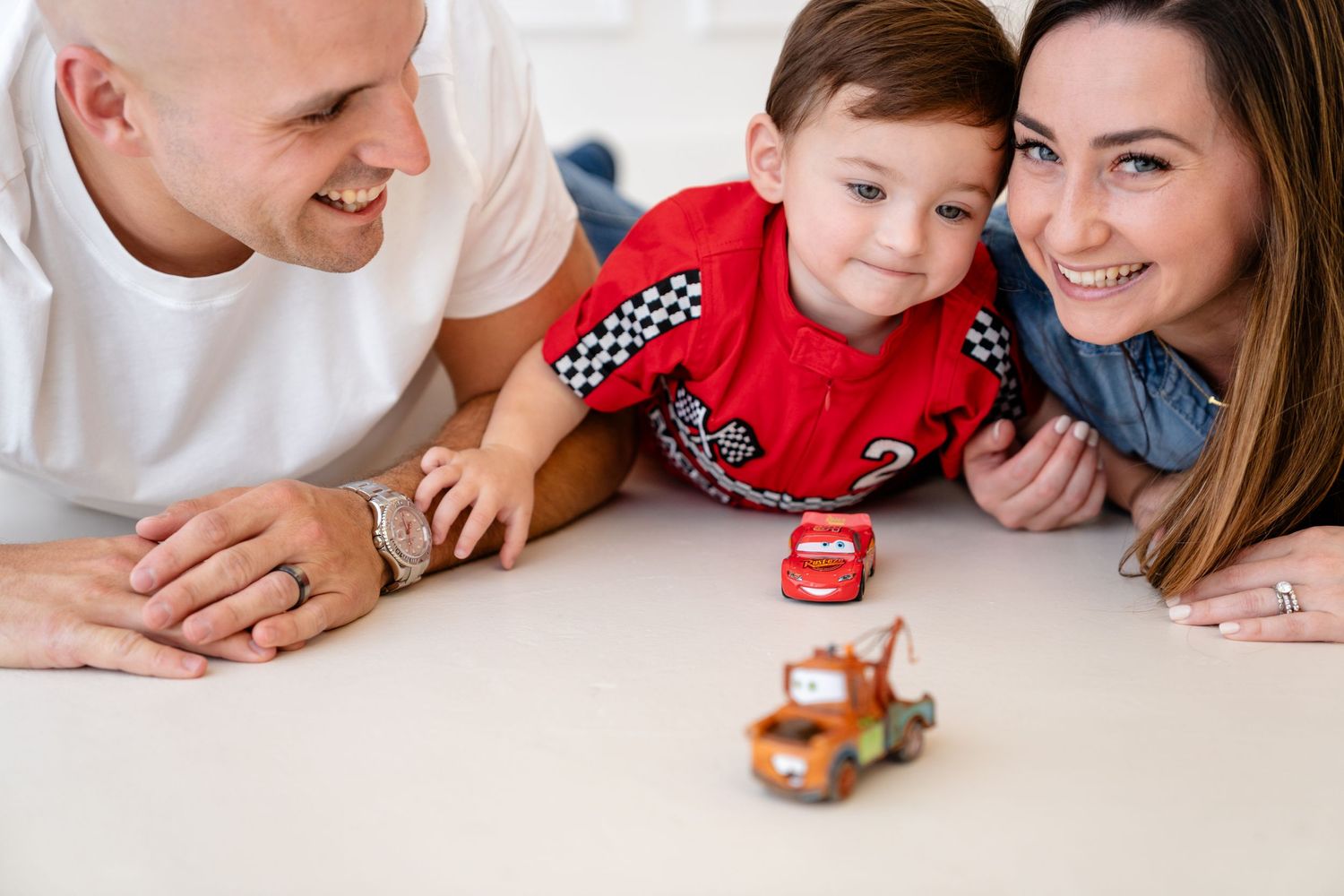 Four connected toy car photos showing a red and brown toy car being played with on a white surface.