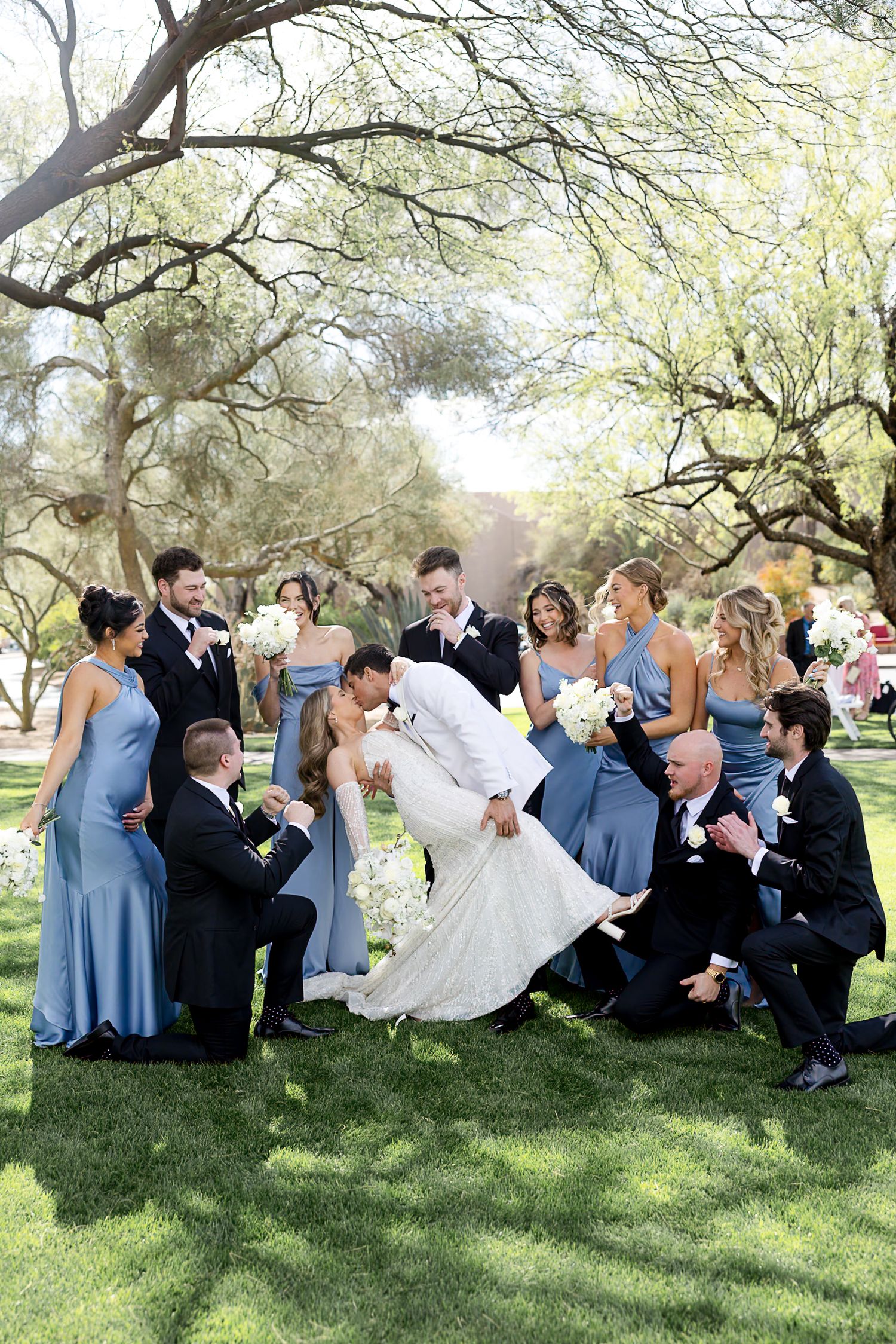 Romantic desert wedding photos showcasing couple in elegant attire against rugged mountain backdrop during golden hour.