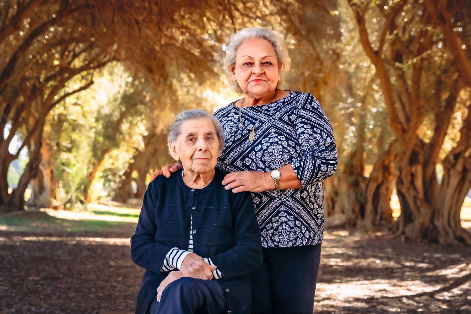 Emotional legacy photo capturing a great-grandmother and her daughter sharing a tender moment during a storytelling portrait session in Clov