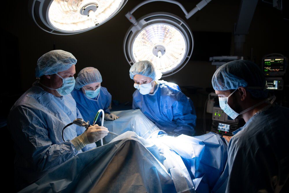 Healthcare professionals conducting surgical procedure in well-lit operating theater.