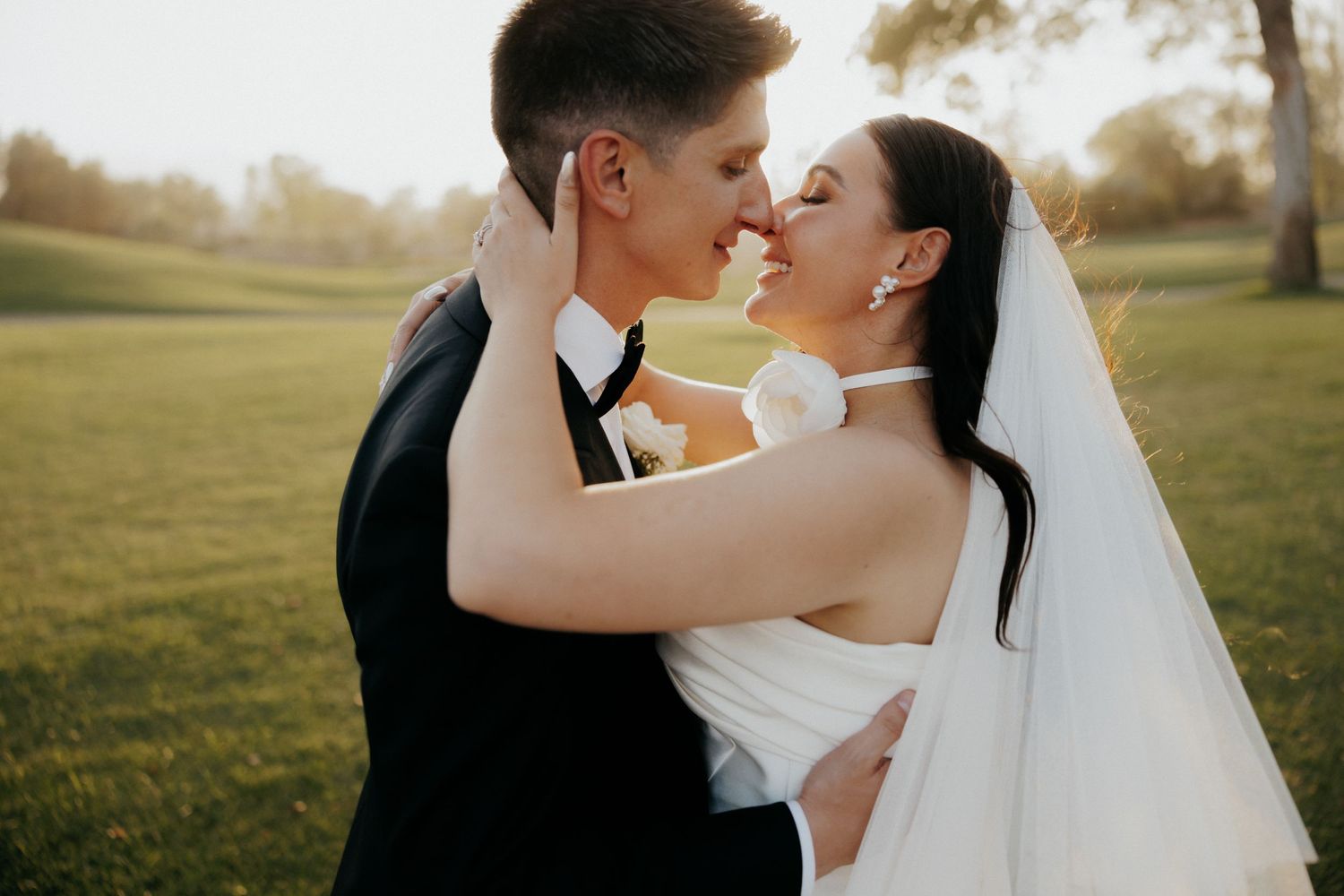 Intimate wedding portrait on a sunny golf course.