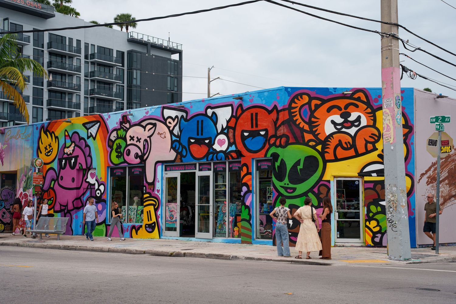 Colorful graffiti mural covering a building exterior in Miami's Wynwood Arts District with cartoon characters.
