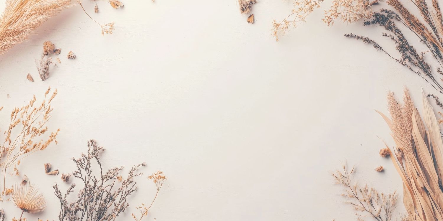 Elegant flat lay of dried wildflowers and pampas grass arranged on a soft white background with copy space.