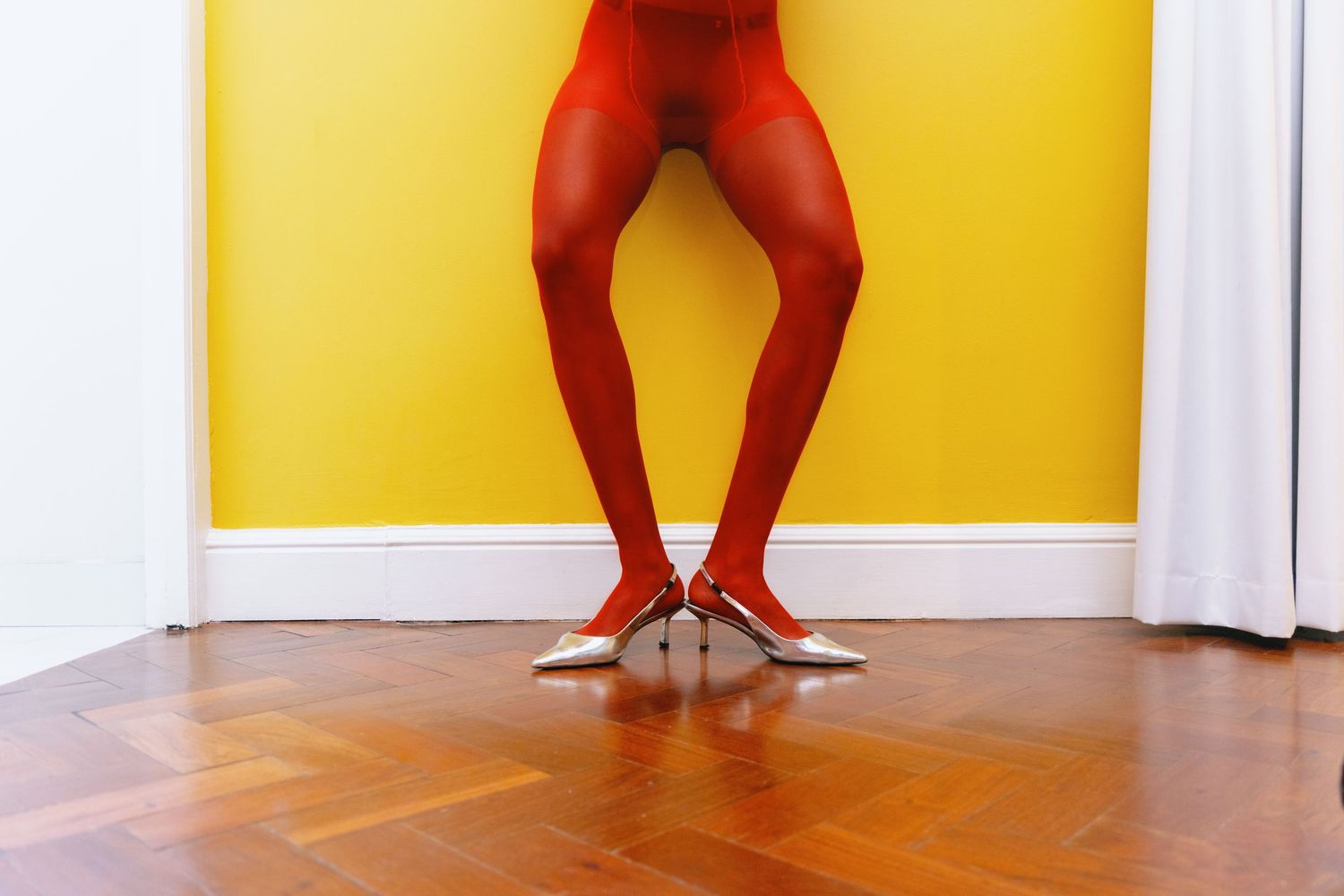 Legs against yellow wall showing different poses and stances.