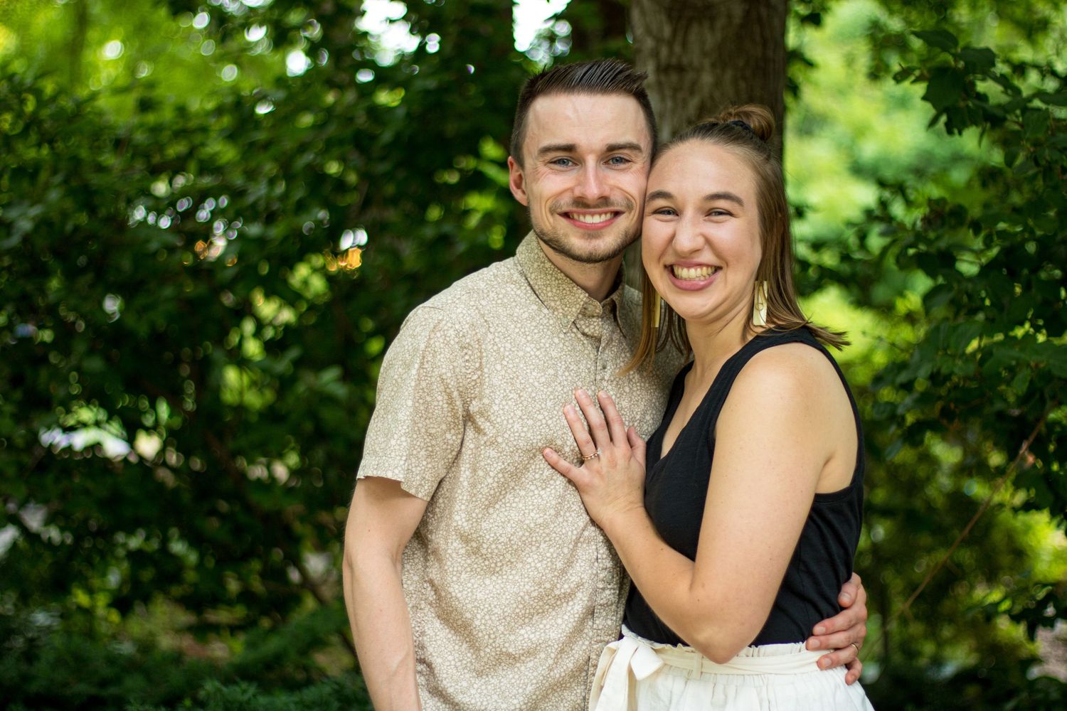 DFW Couples Photography Photographer Greenery Background Couple Smiling Hugging