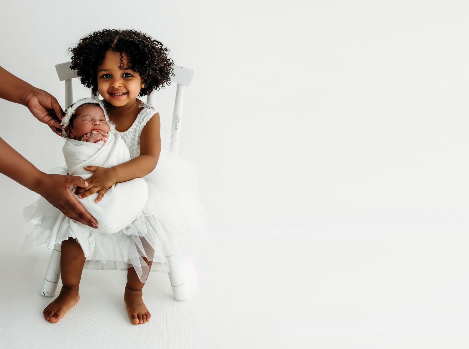 A series of four white-themed photos showing someone sitting on a white background in different relaxed poses.