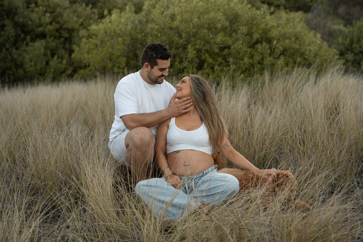 Natural outdoor maternity photography in Wollongong featuring mum and dad in soft evening light.