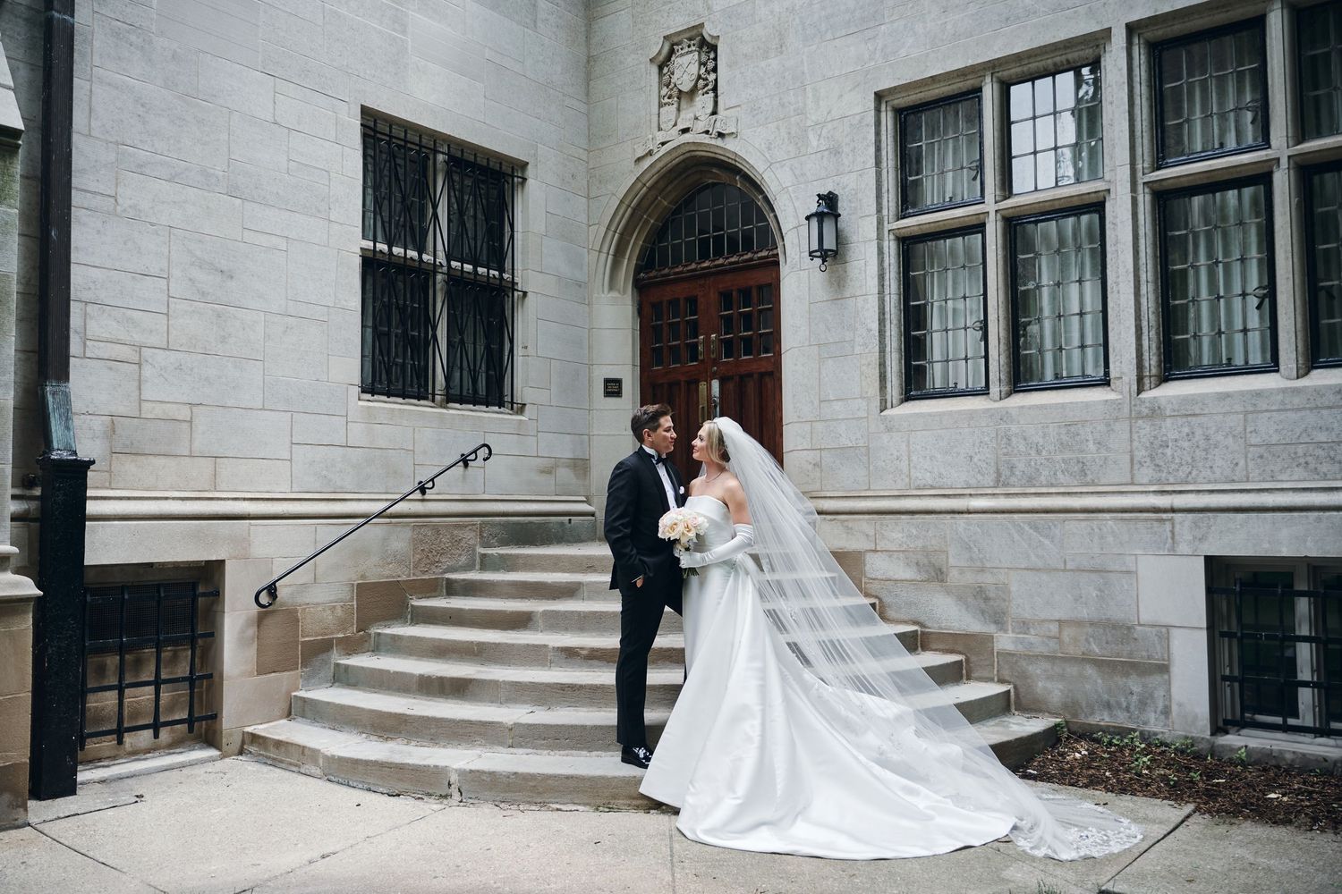 A wedding ceremony takes place in a grand cathedral with ornate Gothic architecture and wooden pews filled with guests.