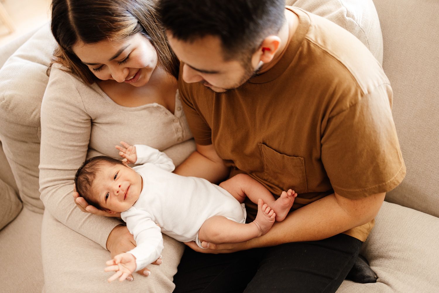 Newborn baby smiles at in-home lifestyle photo session by Bay Area Newborn Photographer Cindy Tucey in Campbell