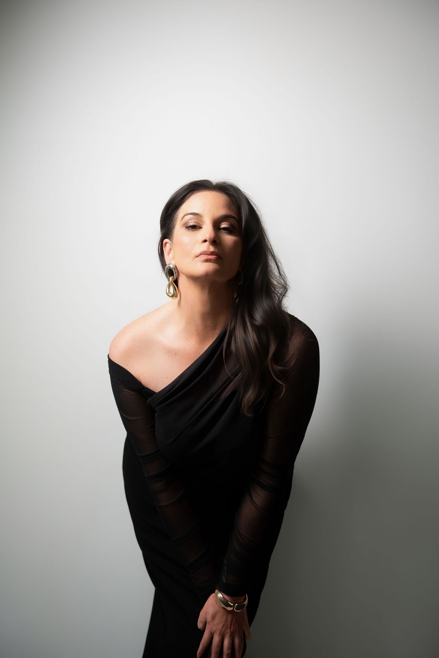 Elegant portrait of a confident woman over 50 in a modern studio, showcasing timeless beauty and sophisticated style.