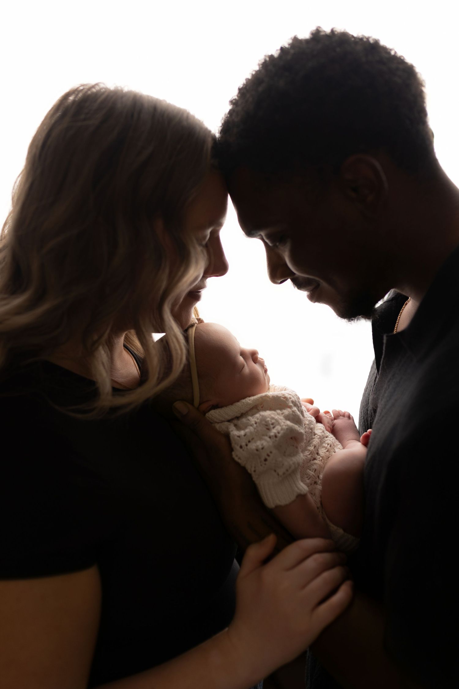 Parents with newborn baby girl in studio at Tiffany Bergamino Photography in Marion Indiana