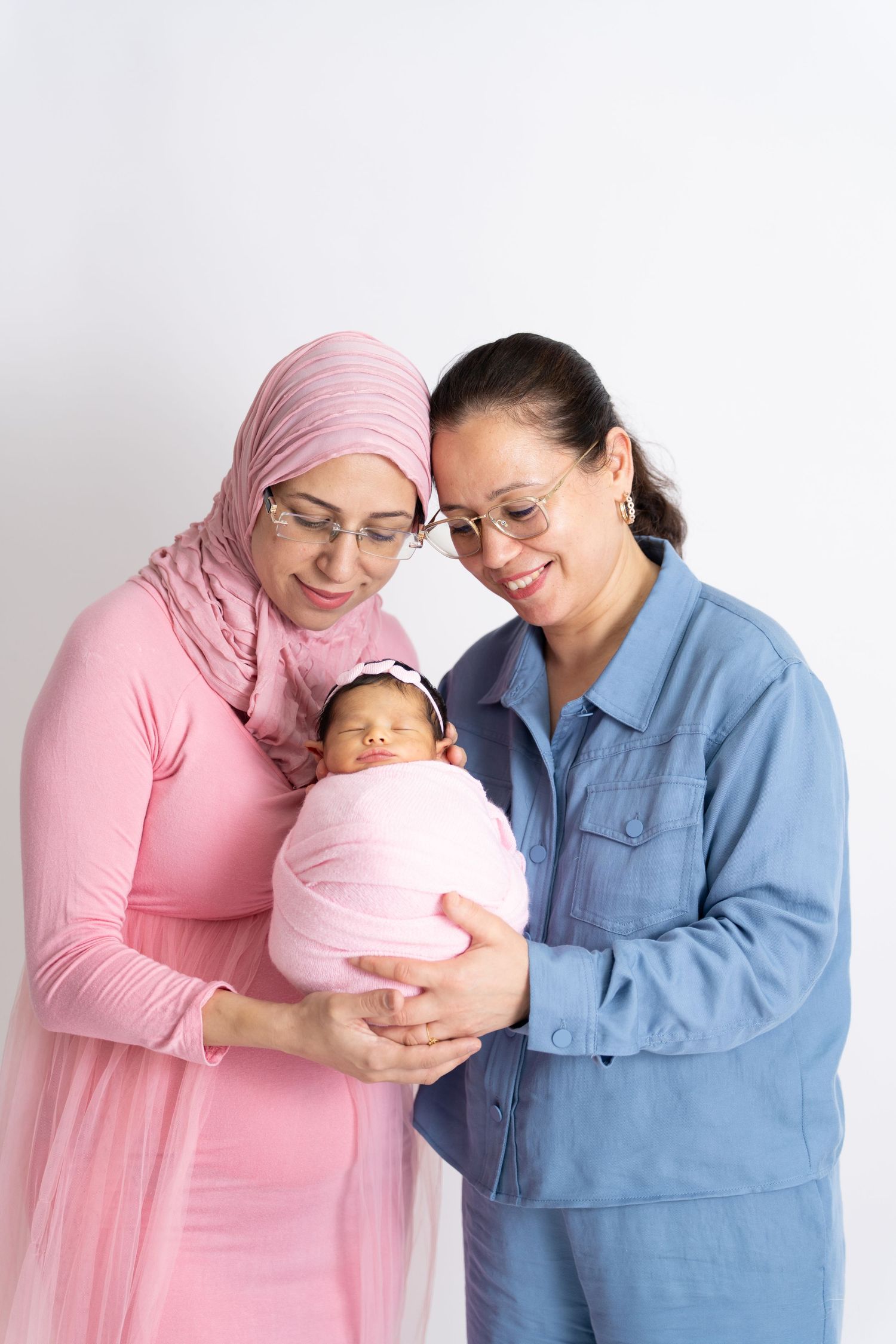 Family photographer Dubai capturing a happy family portrait at Mohastudio photography studio in Dubai.