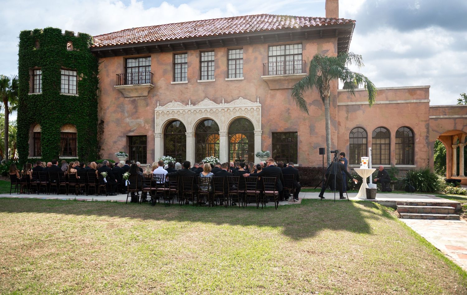 Bride walking down the grand staircase of Howey Mansion, captured by luxury wedding photographers in Florida.