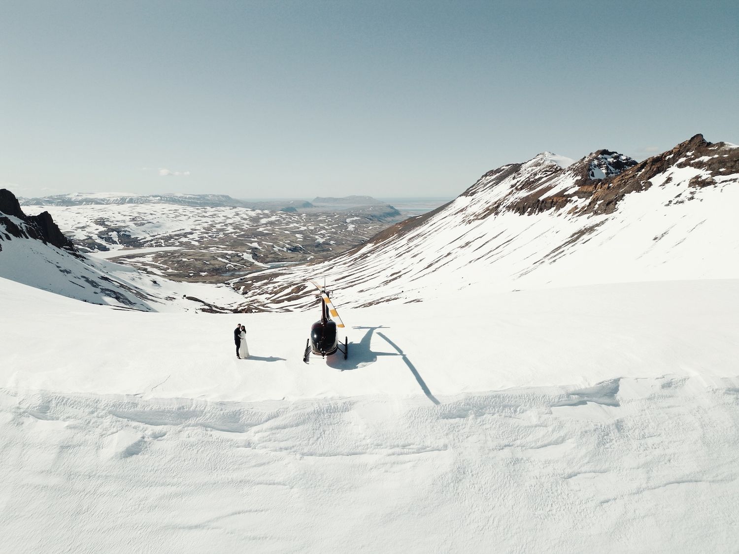 Snow-covered mountain landscape with dramatic winter scenery stretching across multiple peaks.