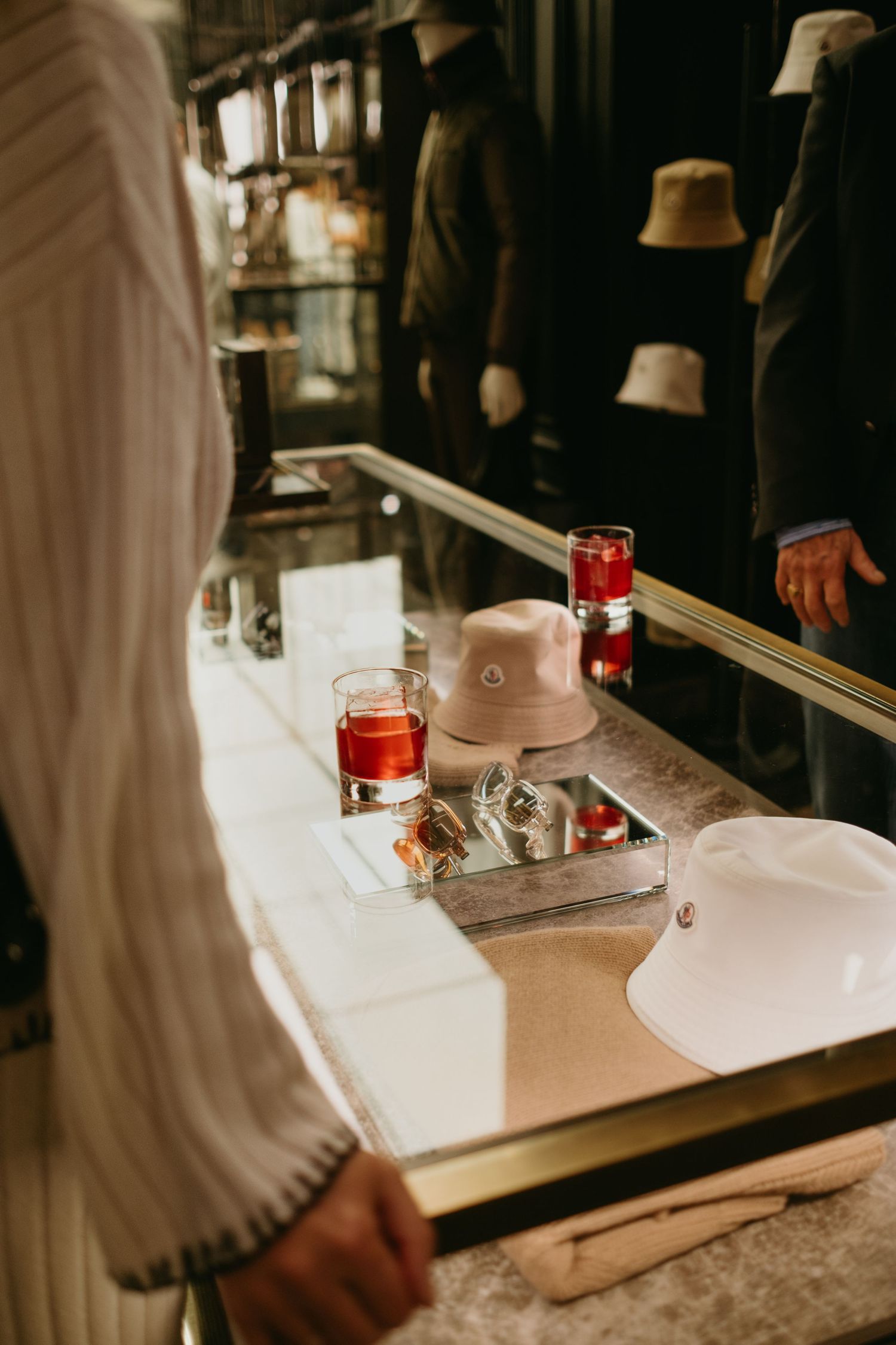 detail of cocktails on a glass shelf in Moncler Store captured by the best event photographer in Stockholm