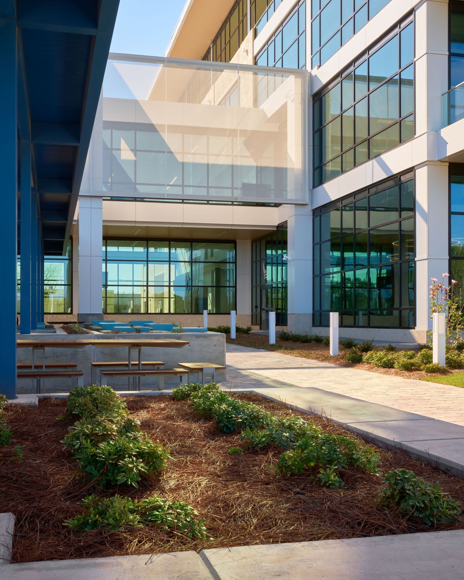 Modern office lobby with textured wall, mission statement signage, and large windows.