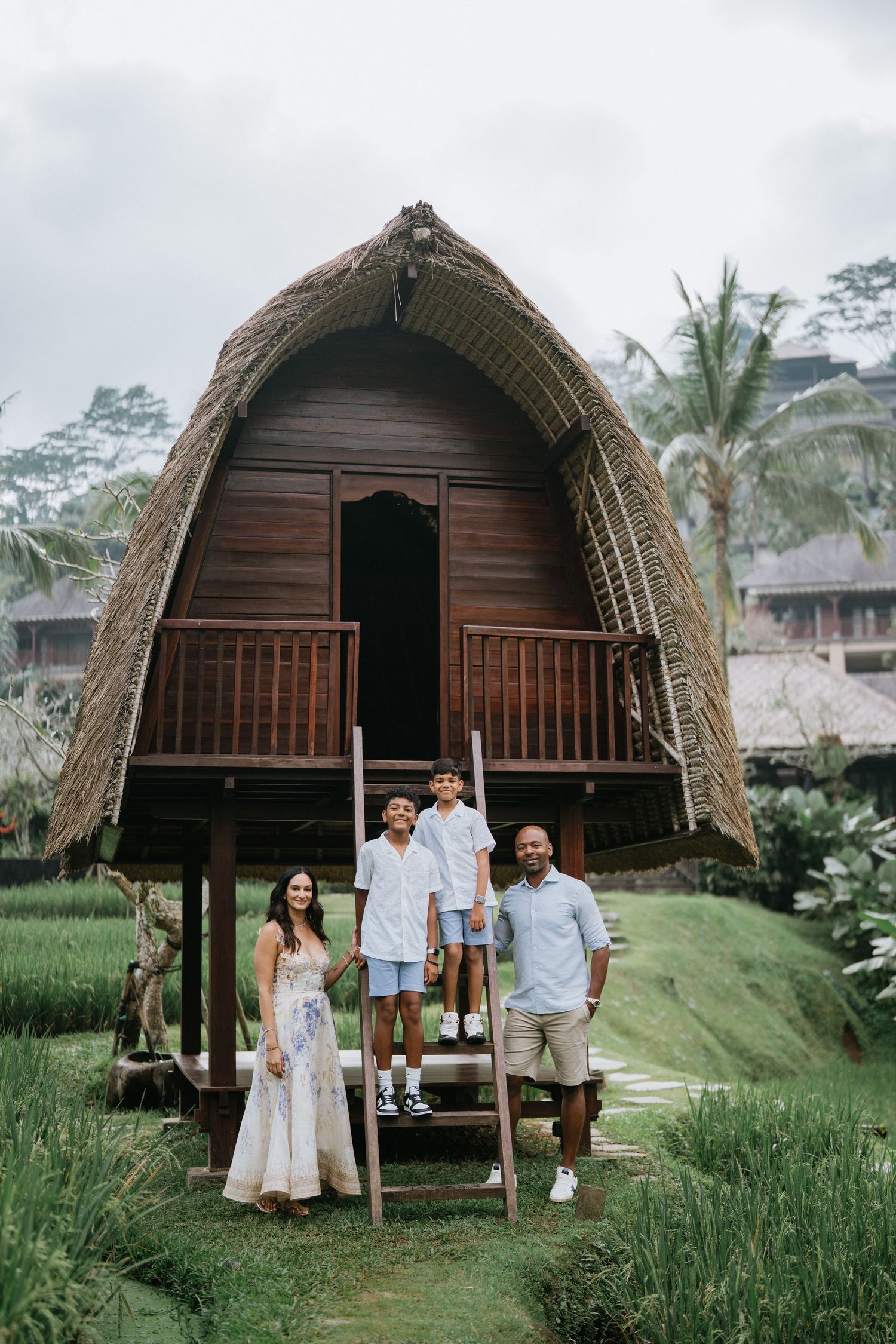Couples share tender moments on a tropical patio surrounded by palm trees.