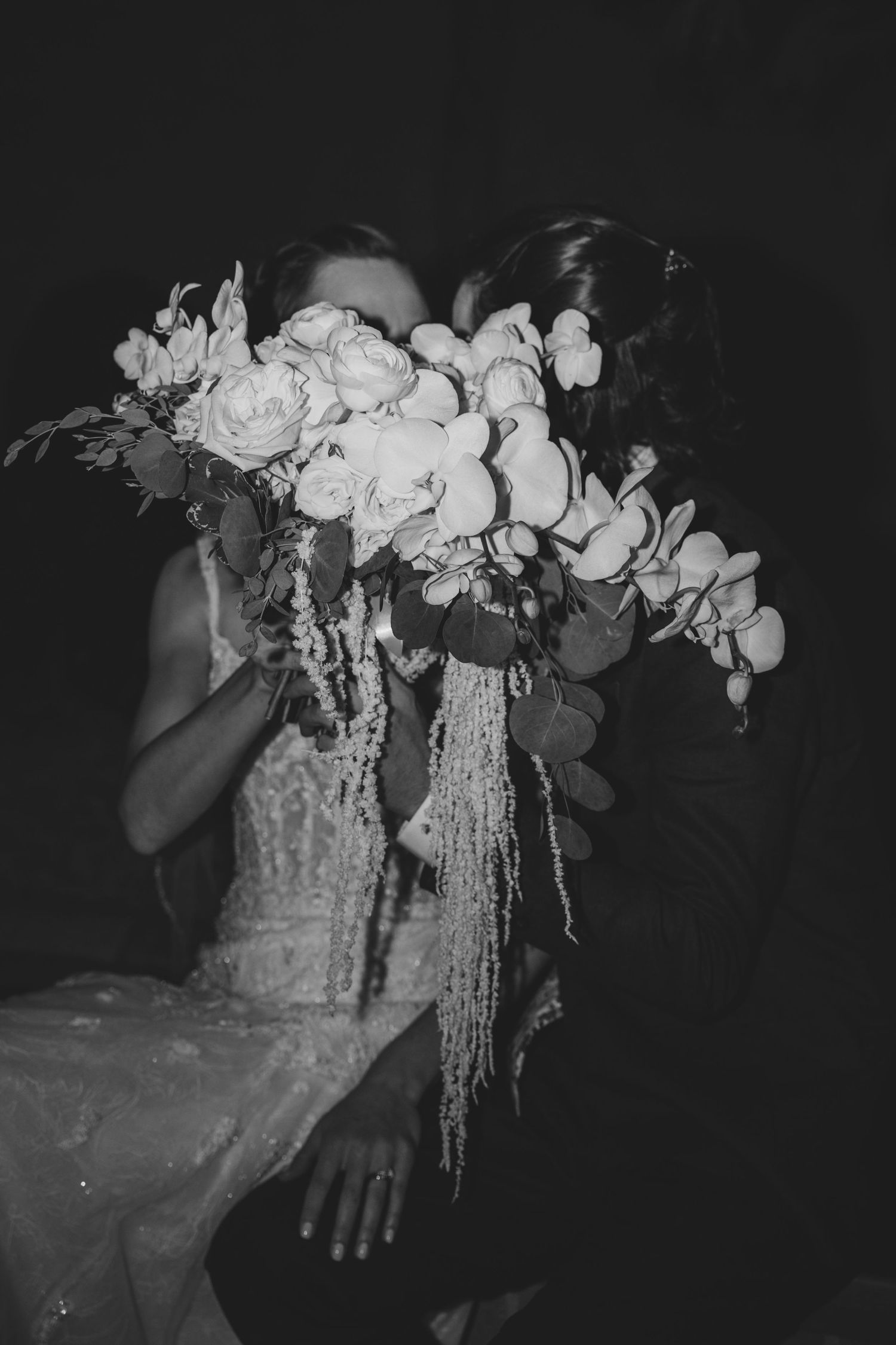 Black and white photo series showing an elegant floral bouquet with cascading white flowers and orchids.