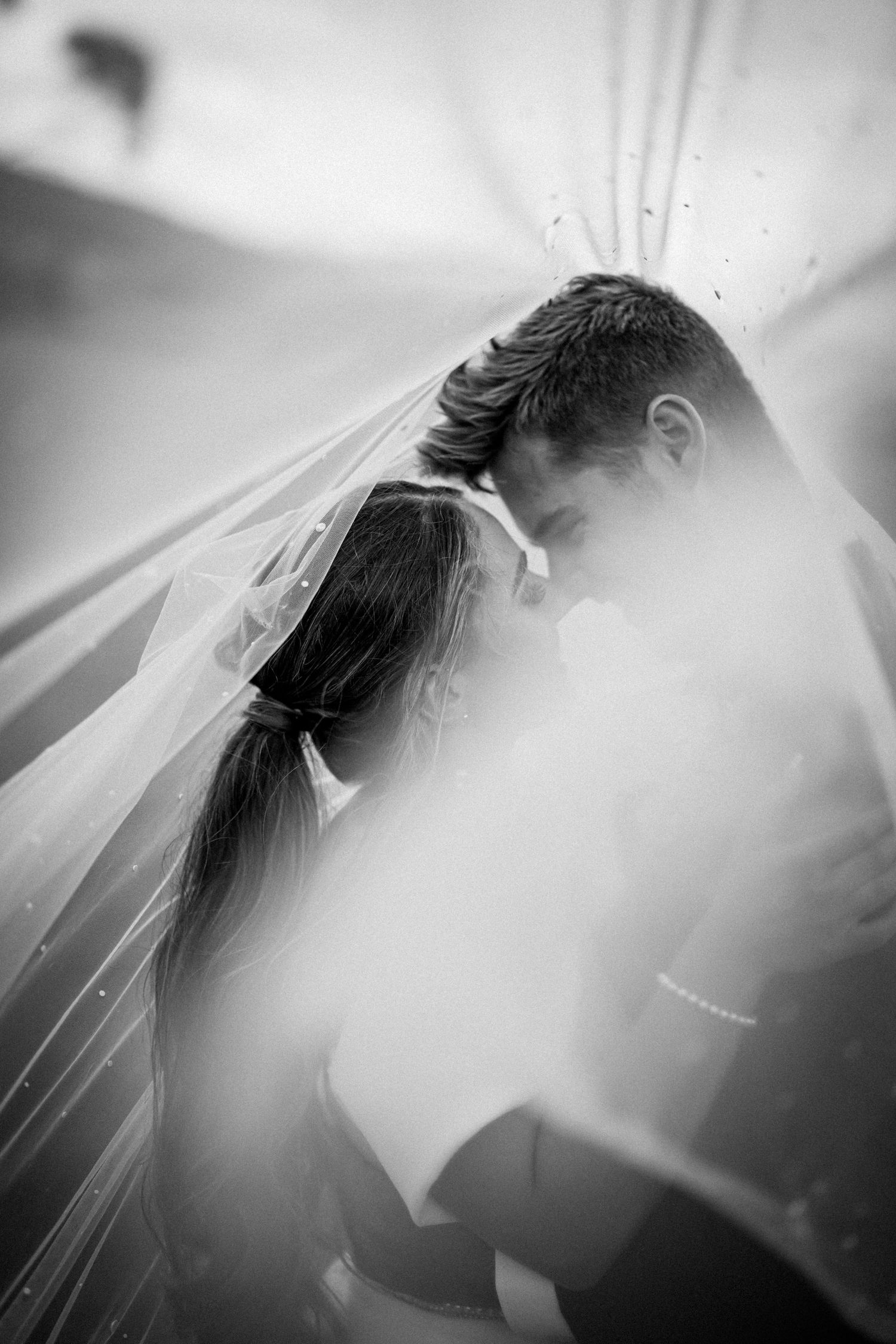 Wedding exit celebration with guests creating sparkler tunnel for dancing couple.