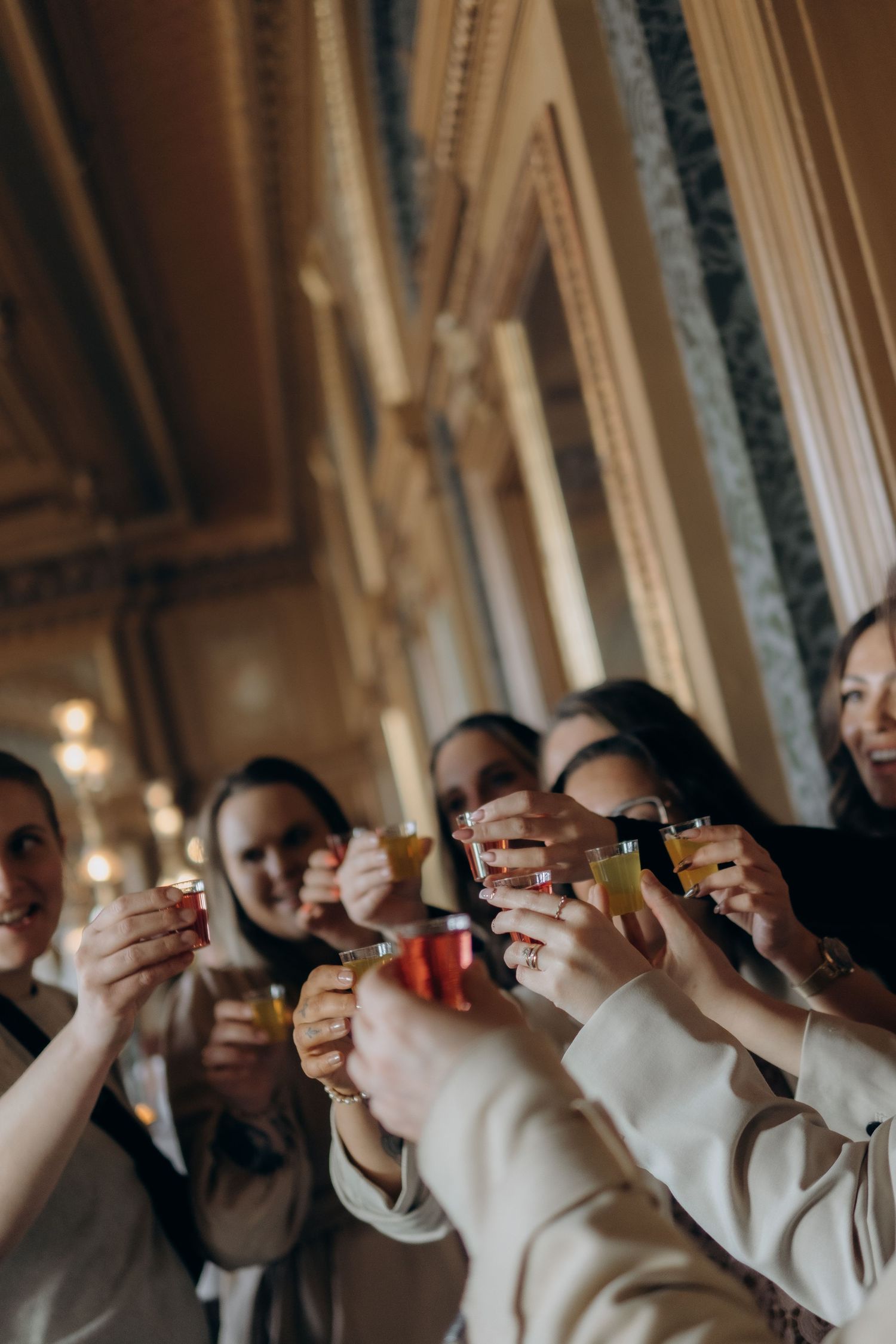 group of women cheering with glasses of juice at Berns Hotel while being captured by professional event photographer in Stockholm