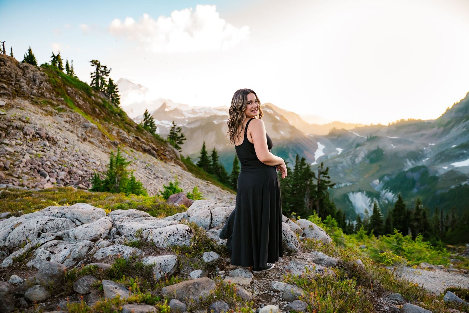 senior girl spins at Mount Baker in a black dress at sunset
