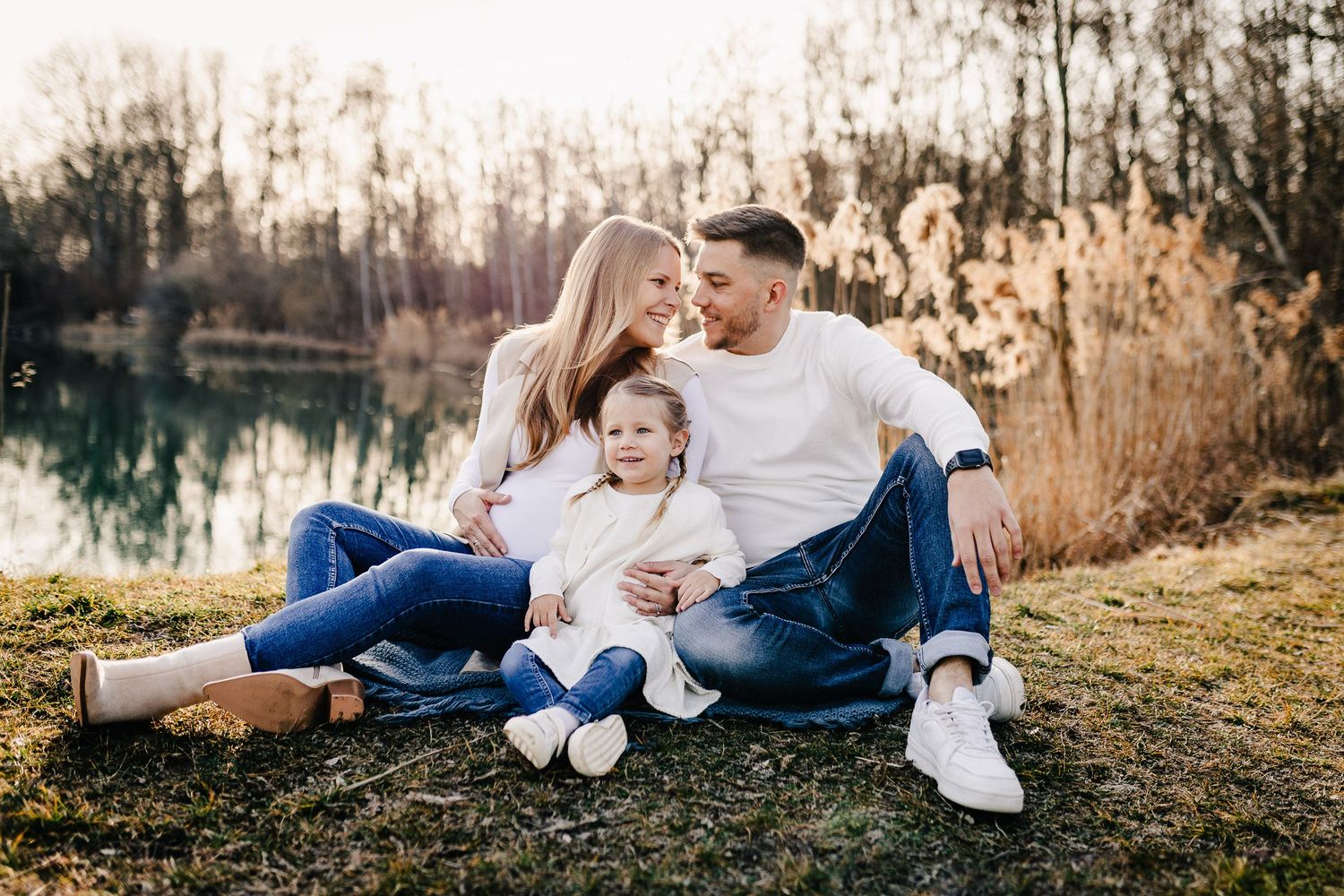 A series of outdoor family photos taken at sunset in a field with tall golden grass and natural lighting.