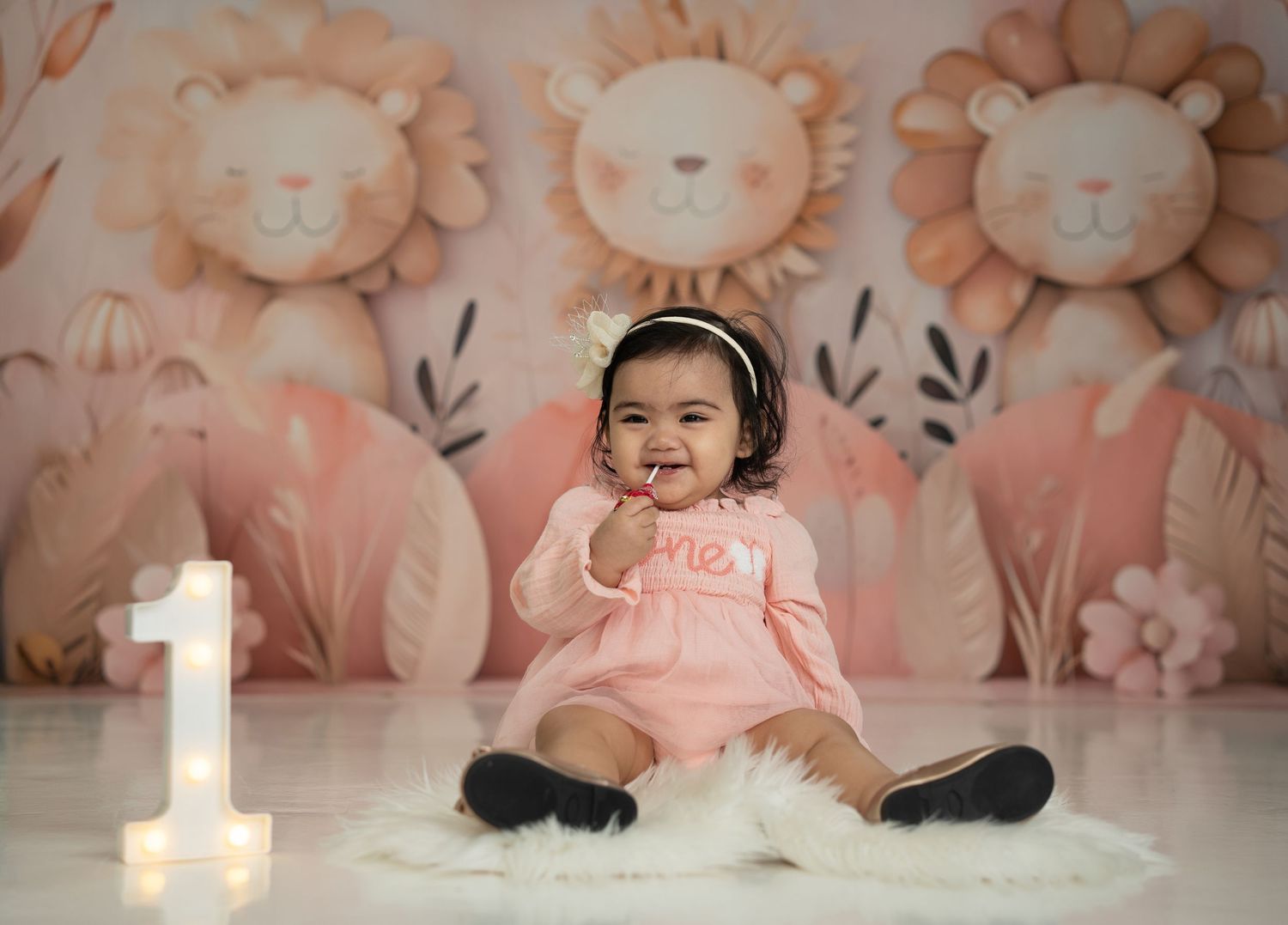 Baby enjoying a colorful Cake Smash Photoshoot Dubai setup by Mohastudio.