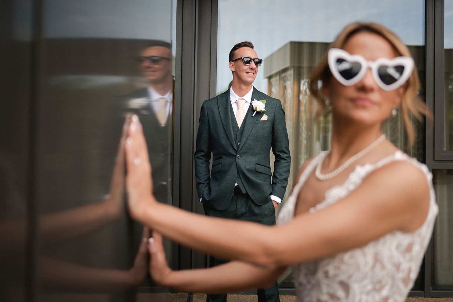 A couple in wedding attire shares an elegant dance moment in formal attire.