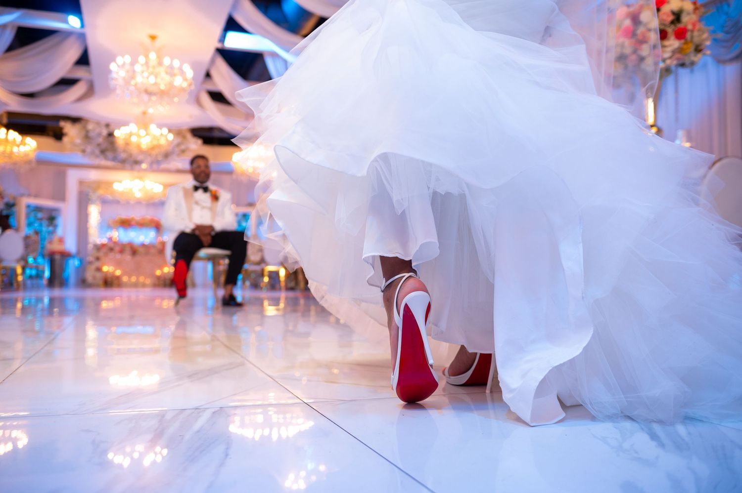 They show off their red bottom shoes during their portrait session.