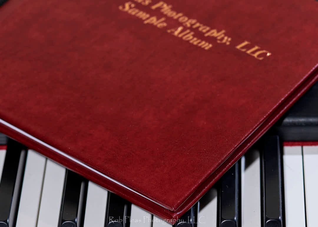 Photo of high school senior memory album with the leatherette cover. Album resting on musical keyboard.