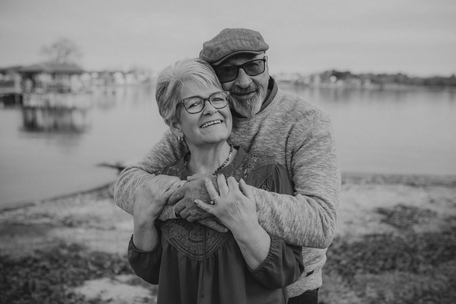 Black and white romantic photo collage showing intimate moments between a couple outdoors in nature.