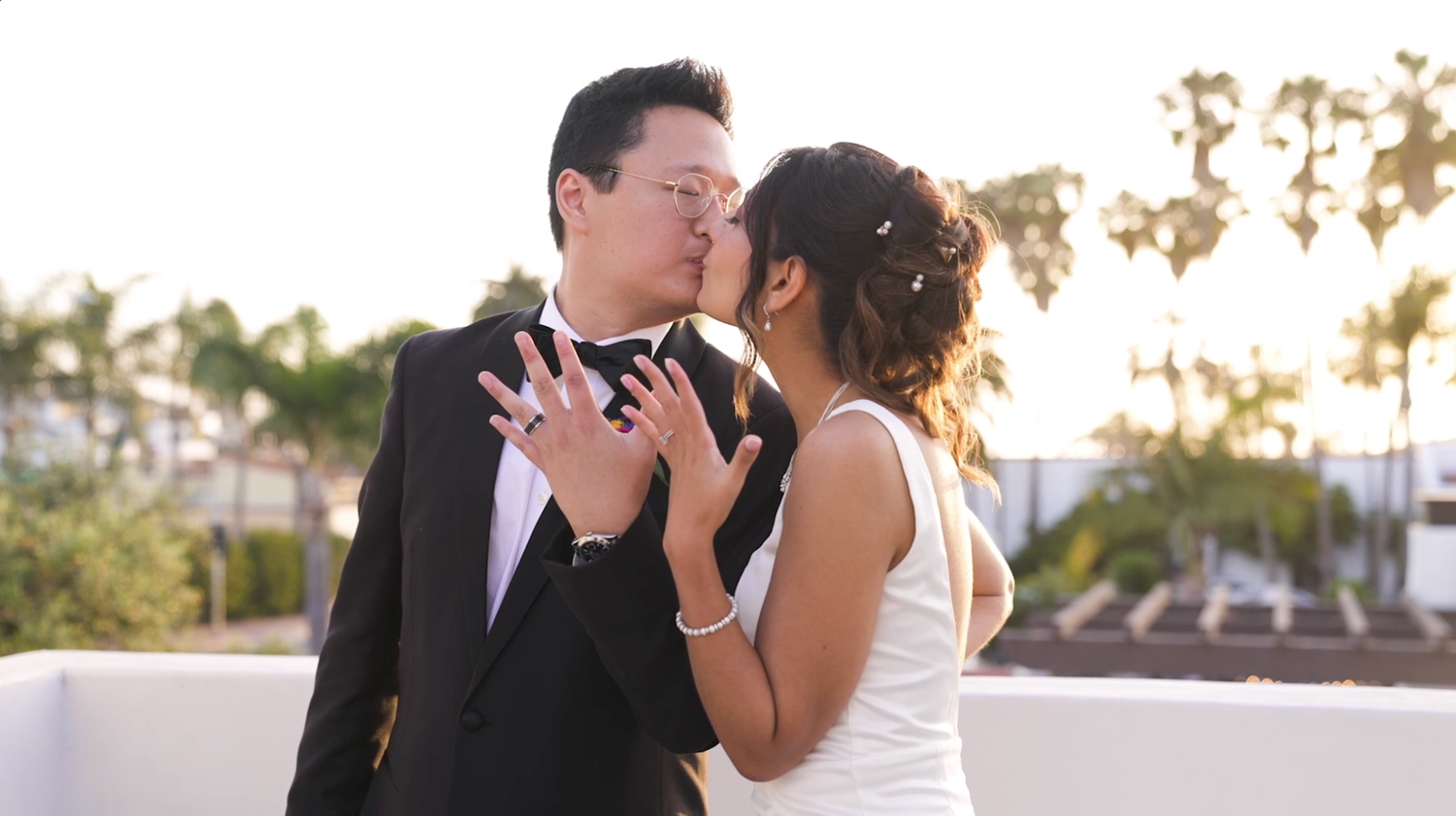 A couple shares a romantic moment during their outdoor wedding photoshoot at sunset.