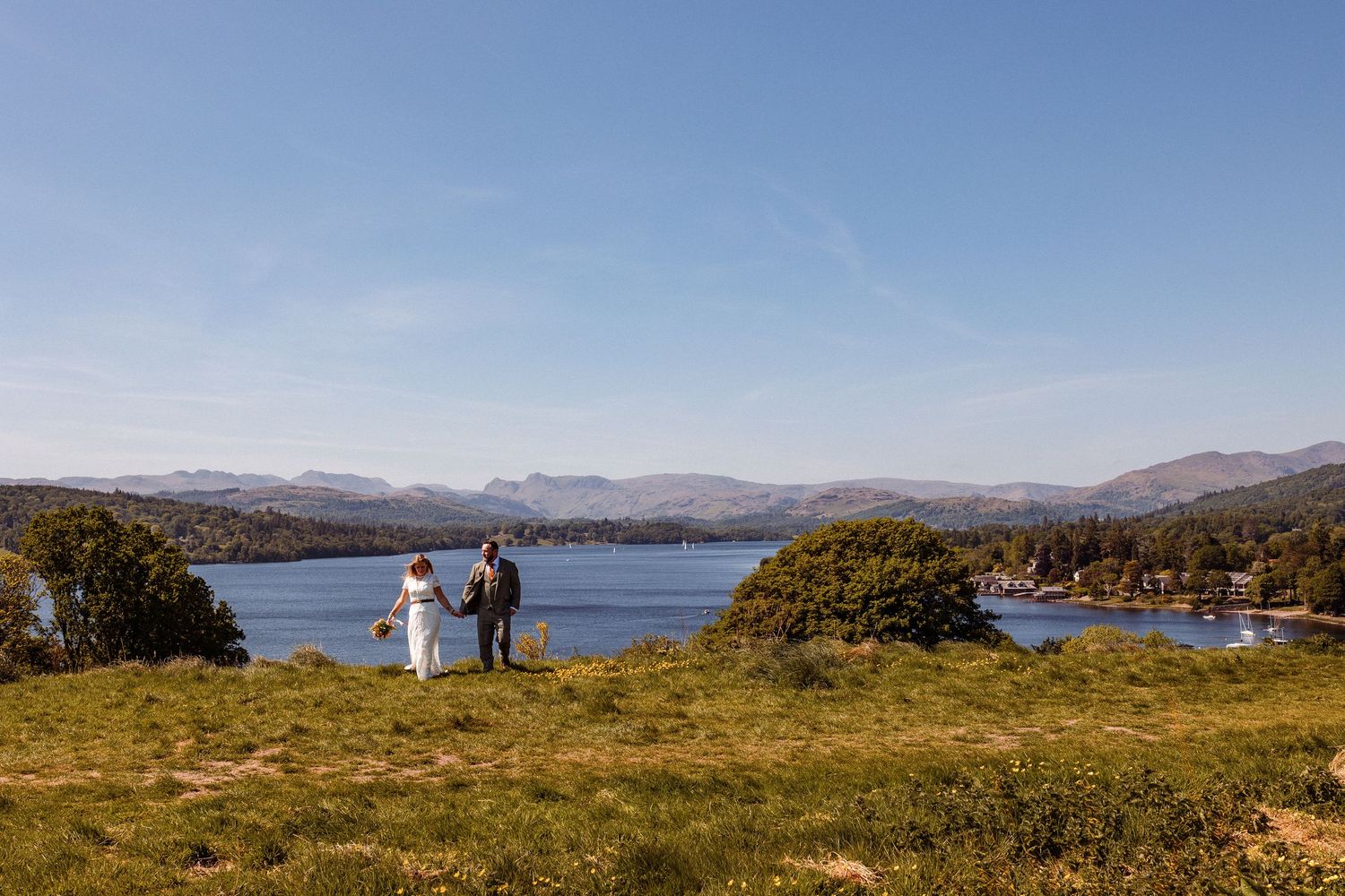Emma and Joe walking hand in hand at Linthwaite House