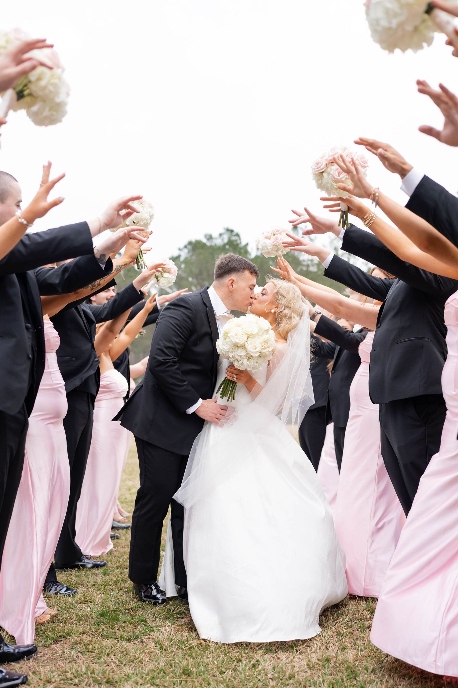 bride and groom under the bridal party bridge