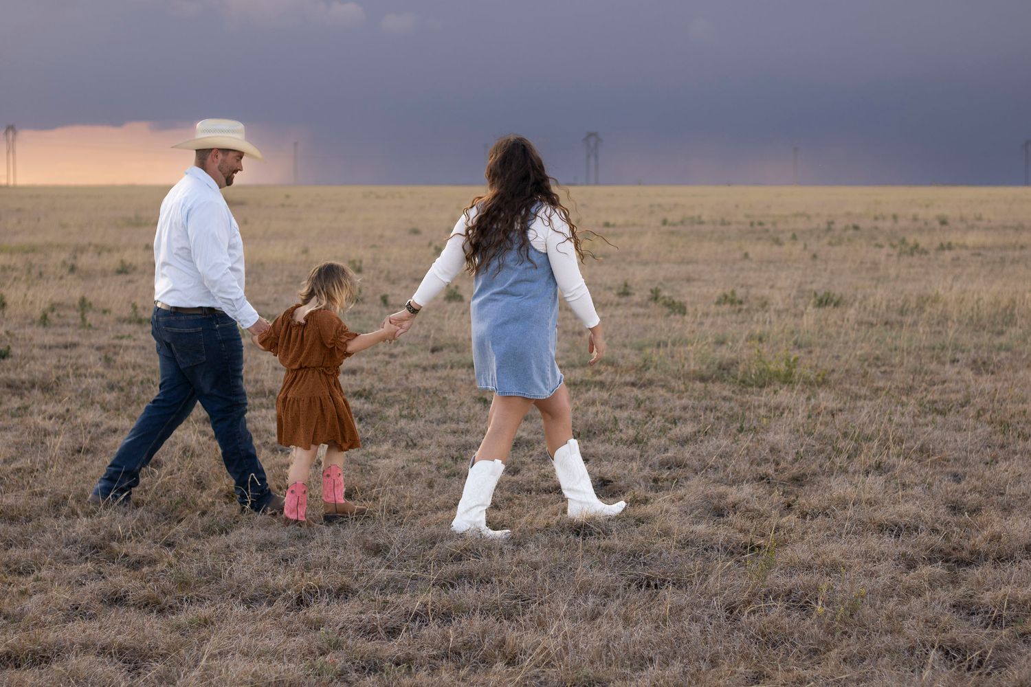 A family of three during a family photo session at an open field in Amarillo, Texas