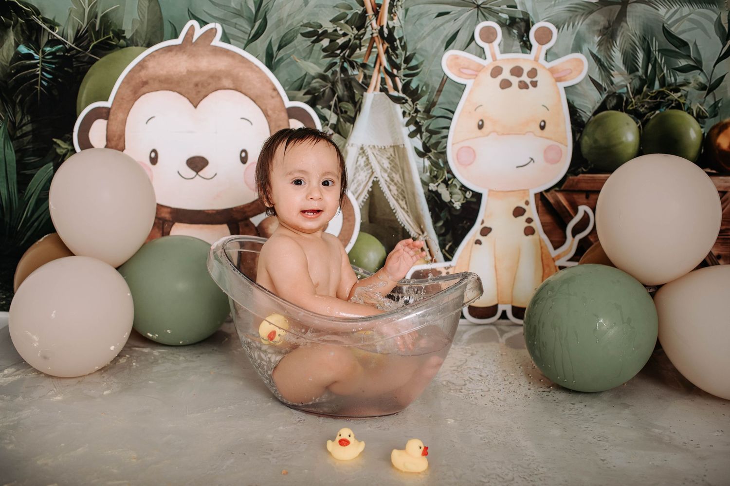 A bath time setup with safari animal decorations, balloons, and candles creating a cozy jungle-themed environment.