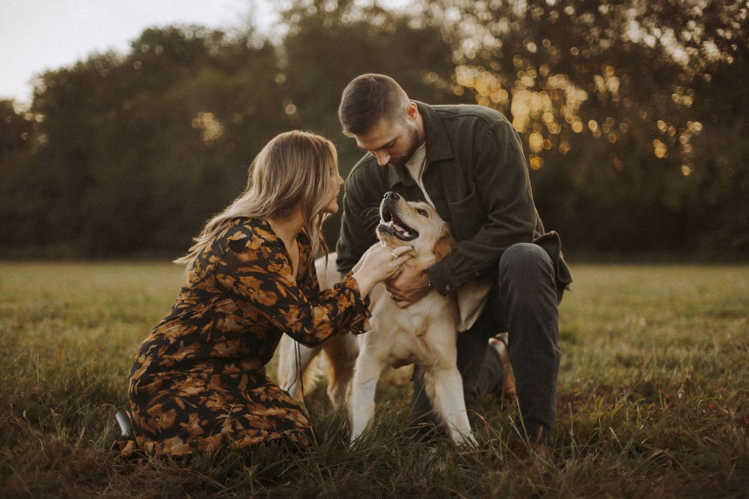 couple photographed with golden retriever dog in golden hour photoshoot in Alabama