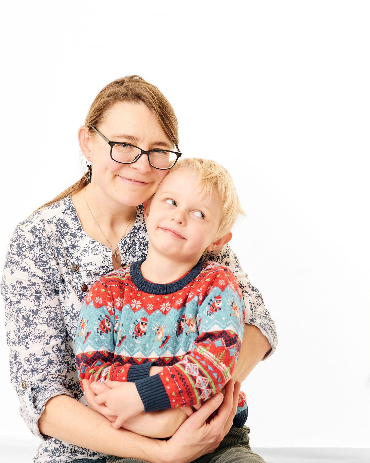 Mother and son in their home having a photoshoot. Mother and child smiling at the camera