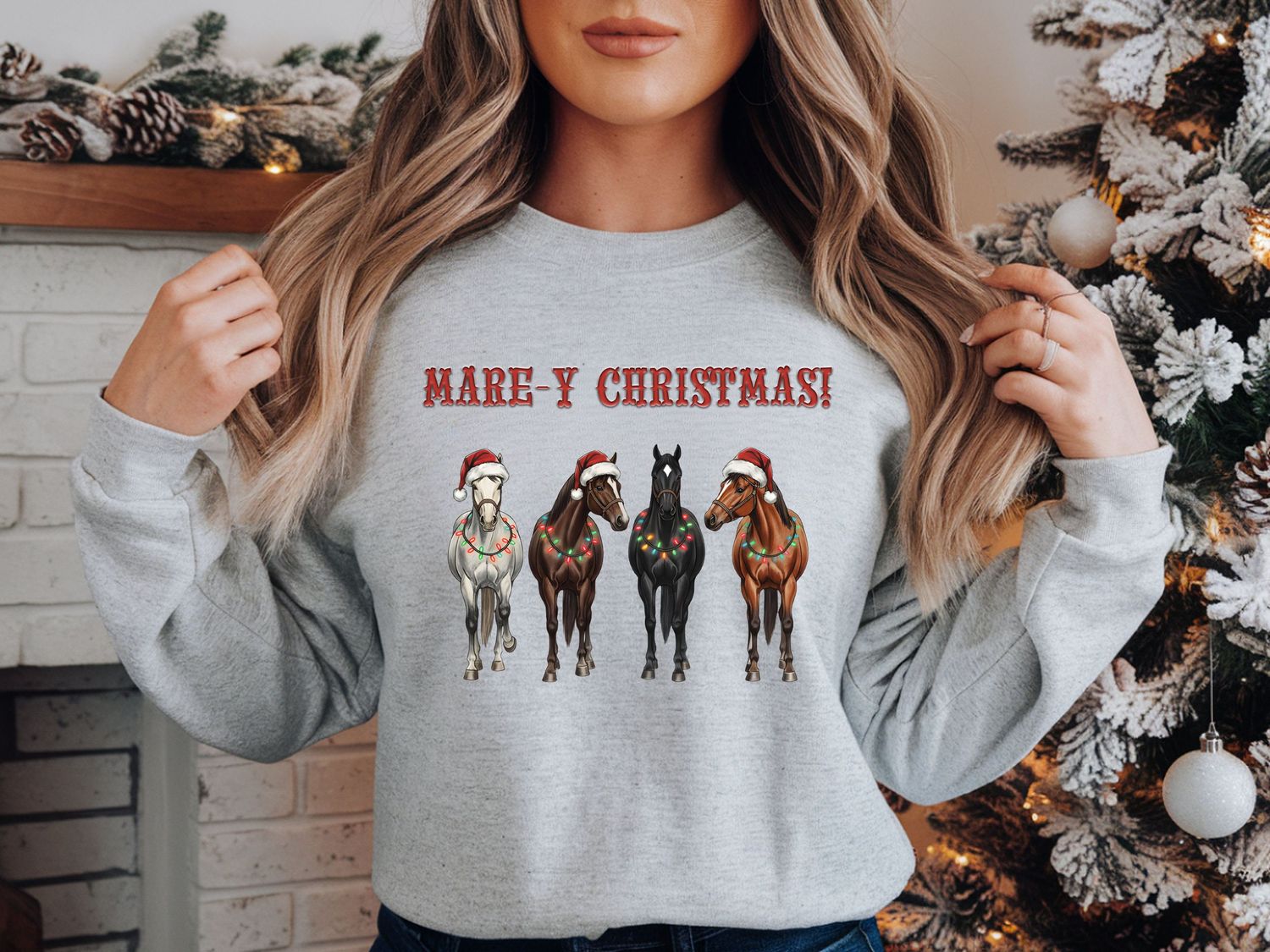 equestrian christmas sweater, mare-y christmas, featuring four horses wearing christmas lights around their neck and christmas hats.