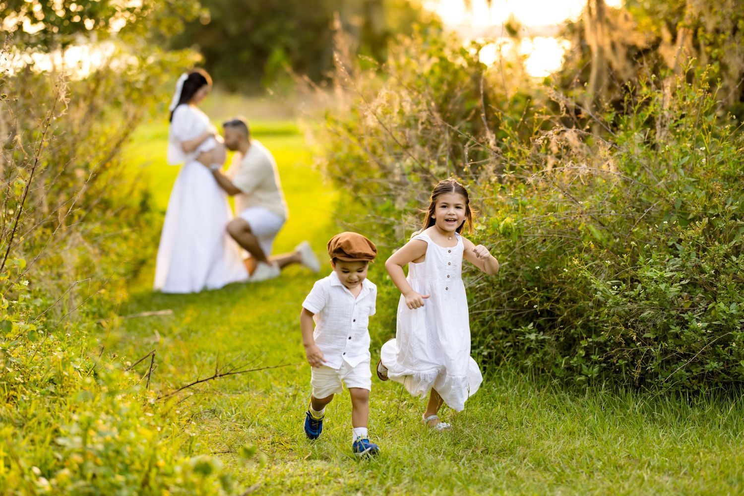 Children playing in a lush meadow during golden hour photography session.