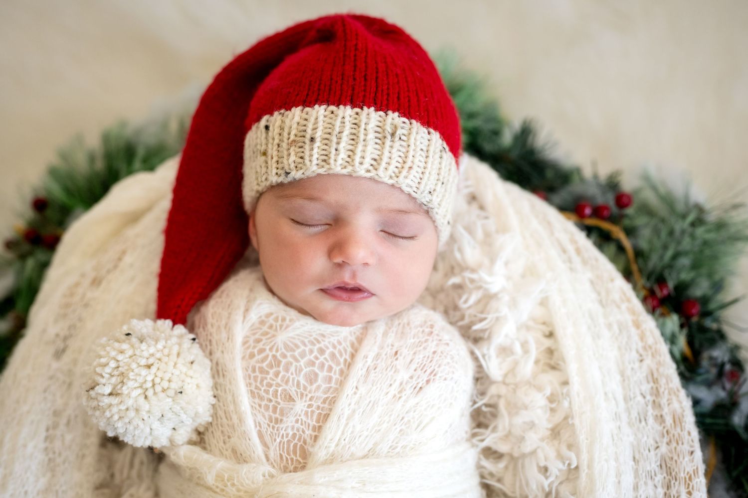 Holiday themed newborn photos with Christmas decorations on white furry background.