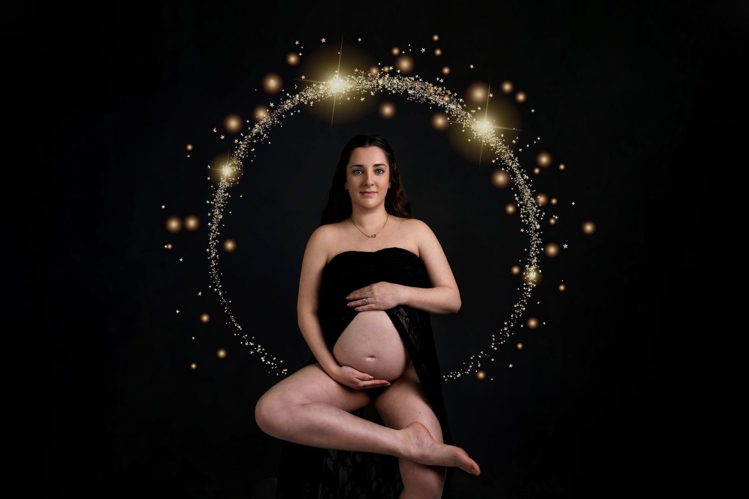 A maternity photo series showing a pregnant figure against a dark background with sparkling light effects.