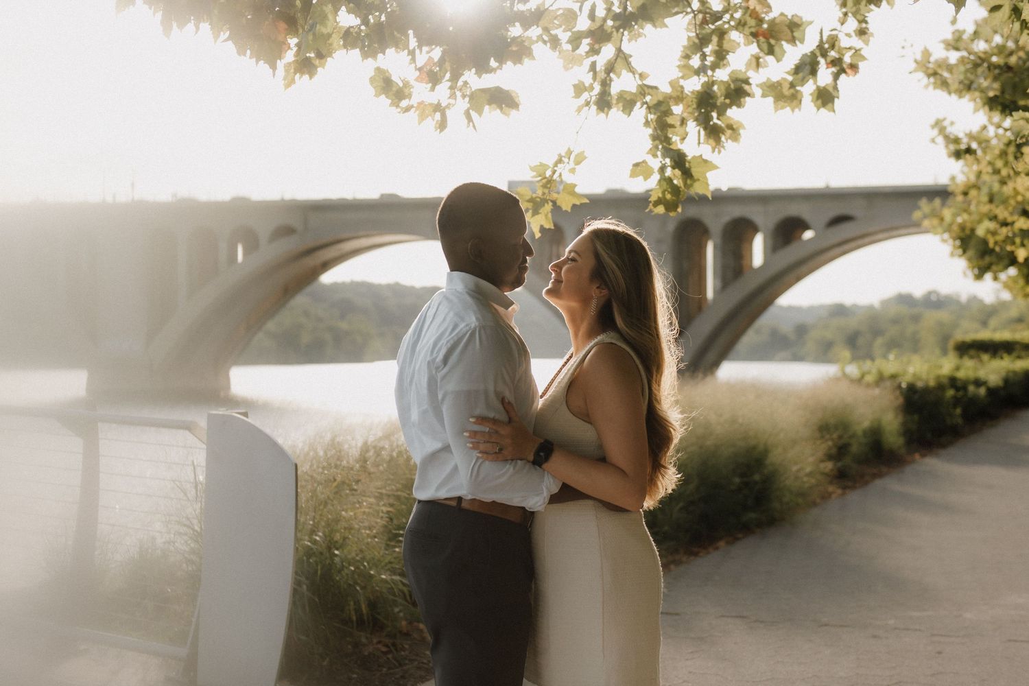 A romantic couple embraces during a golden sunset photoshoot in a Georgetown, Washington DC.