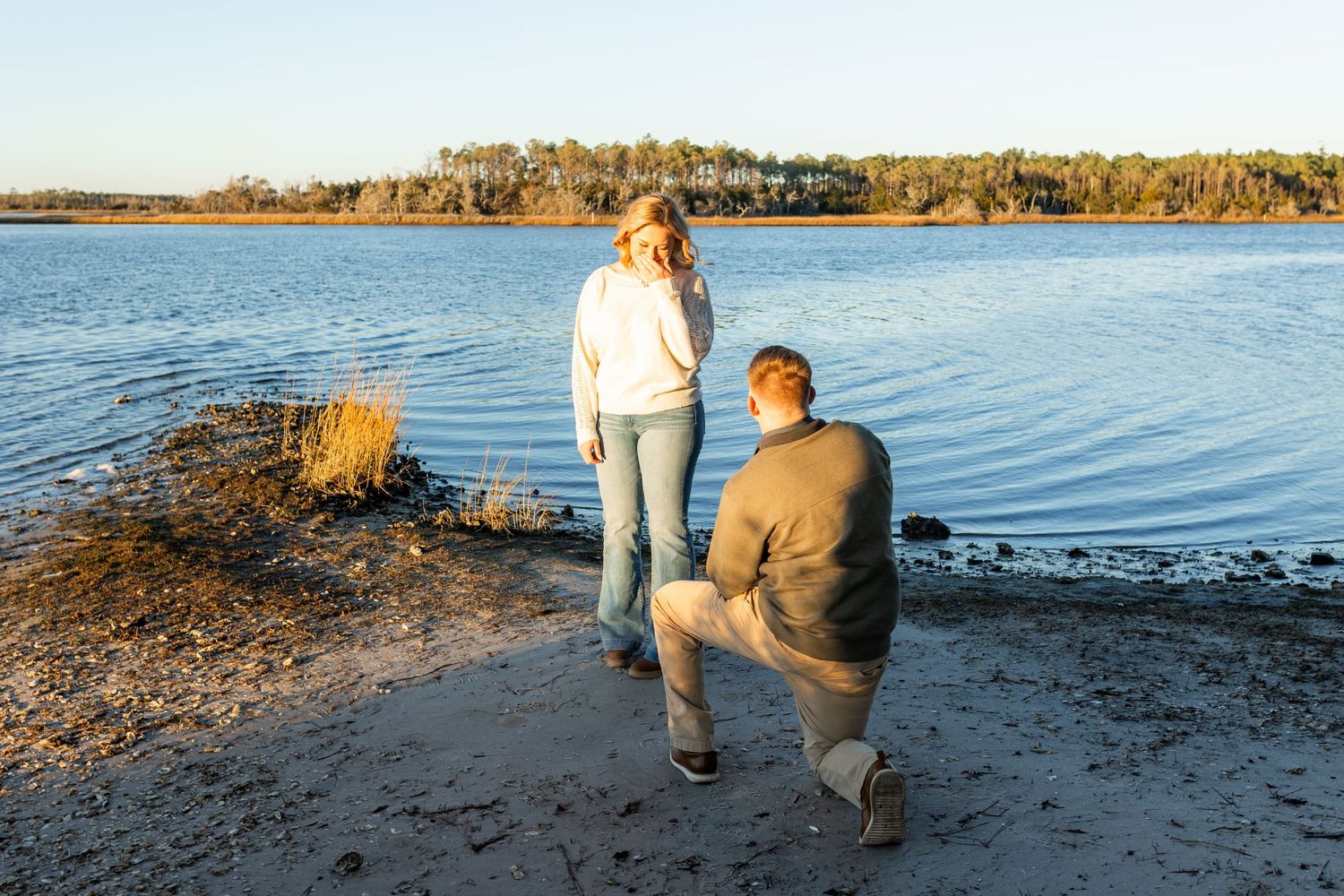Couple celebrating engagement by the Swansboro waterfront during a Crystal Coast photo session