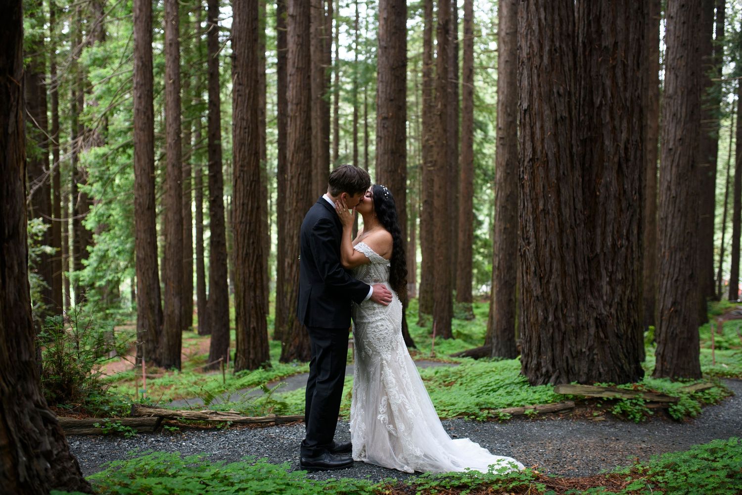 Bride and groom kiss in the Redwood Grove Amphitheatre after their wedding ceremony at UC Berkeley Botanical Garden.