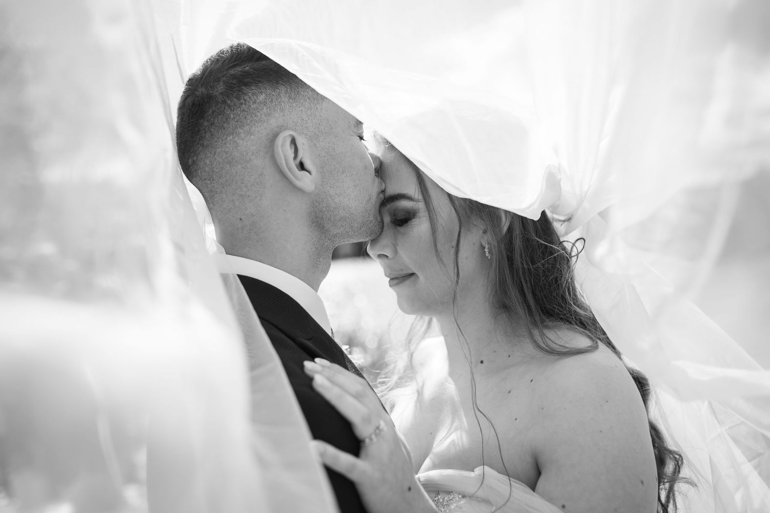 A romantic black and white wedding photo montage showing tender moments between newlyweds during their special day.
